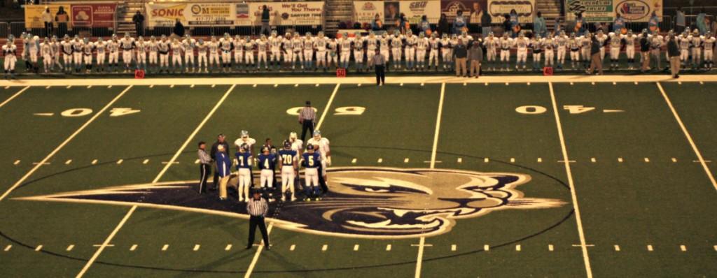 Team+captains+meet+at+midfield+prior+to+the+start+of+the+district+playoff+football+game+against+the+Bolivar+Liberators+at+Southwest+Baptist+University.+Despite+their+efforts%2C+the+Bulldogs+fell%2C+42-14.
