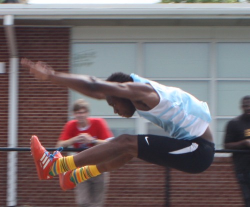 GHS Senior jumper Dayo Akinmoladun stretches for every inch during competition during the track district meet May 17. The event was hosted by GHS.