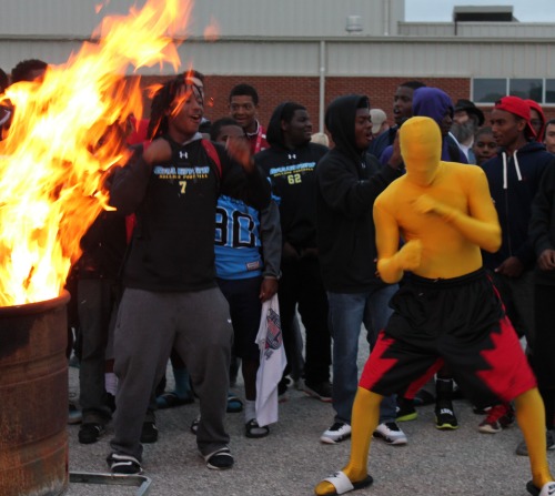 Students enjoy the bonfire Thursday night. The bonfire was one of many activities during Homecoming week. Above, Deauntae Moss fires up teammates.