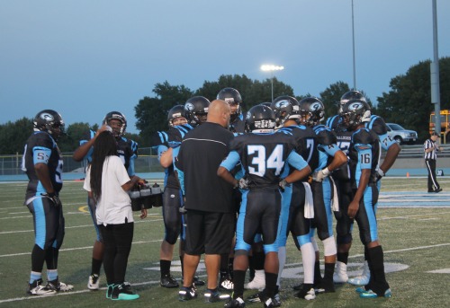 Coach Picard discusses the game plan with his players. 