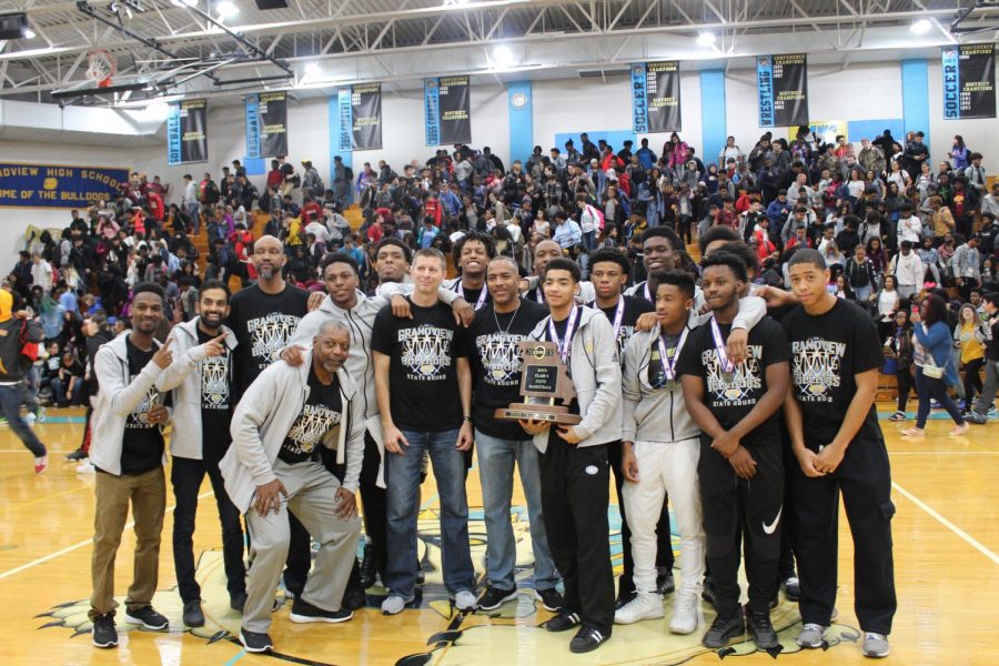 The GHS boys basketball team celebrates its first-ever state championship during a pep assembly at the school.