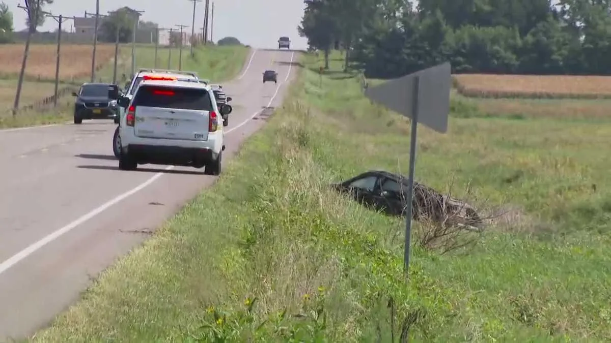 Emergency responders at a rollover crash scene on a rural Polk County road